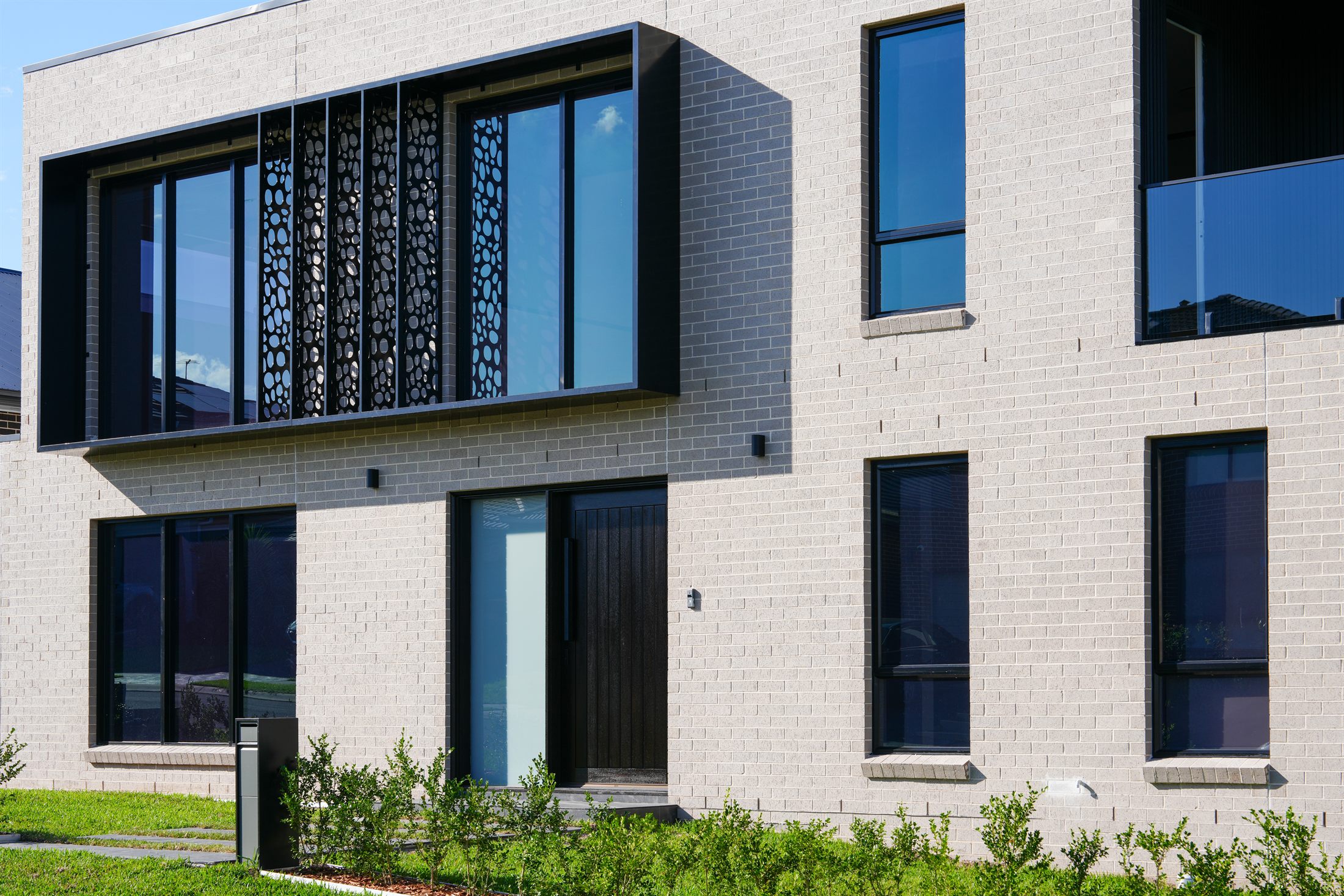 Front facade of a completed two-storey brick home built by Auzzy in Western Sydney